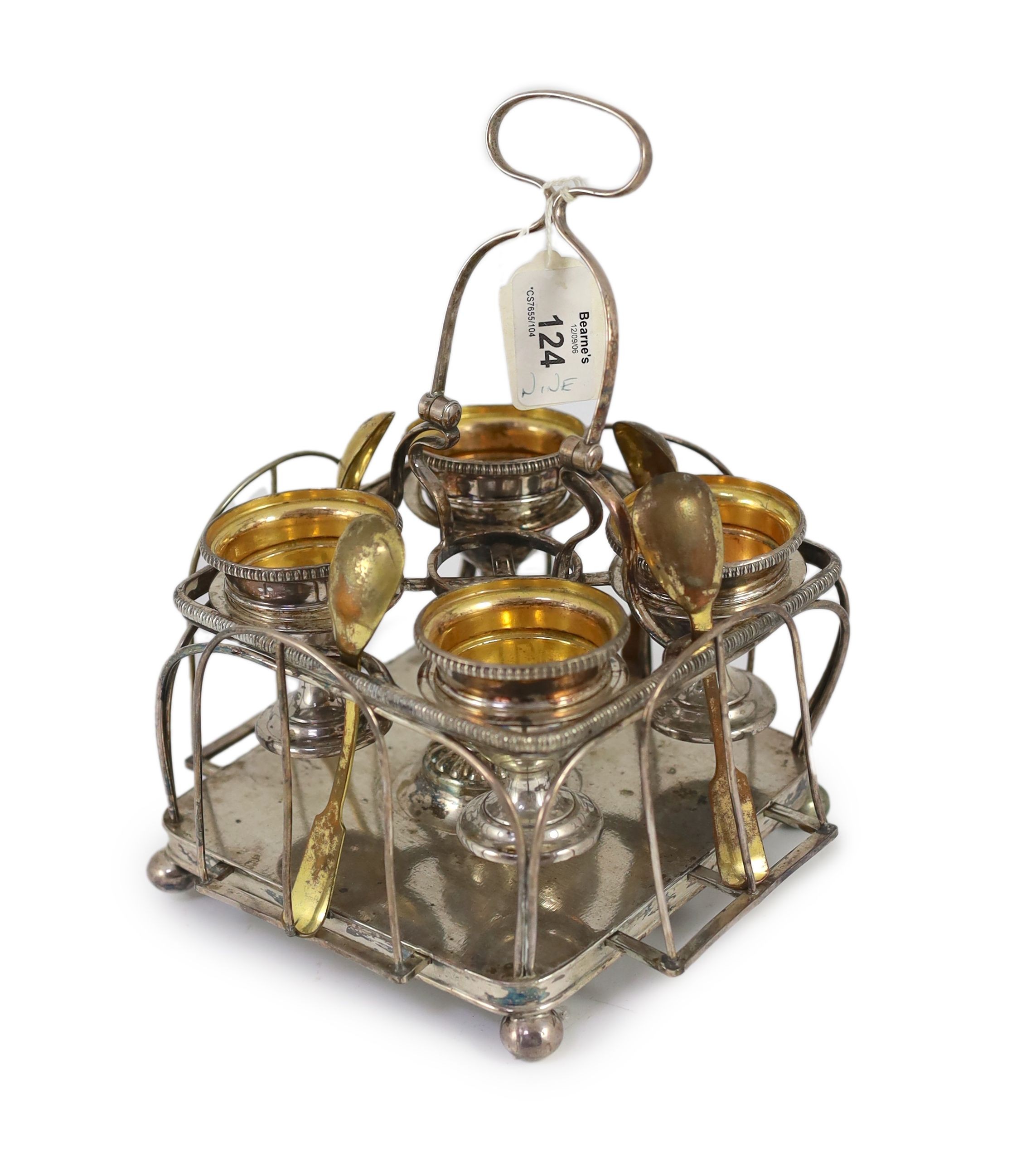 A Sheffield plate egg cruet with four egg cups and spoons, 15cm wide 22cm high